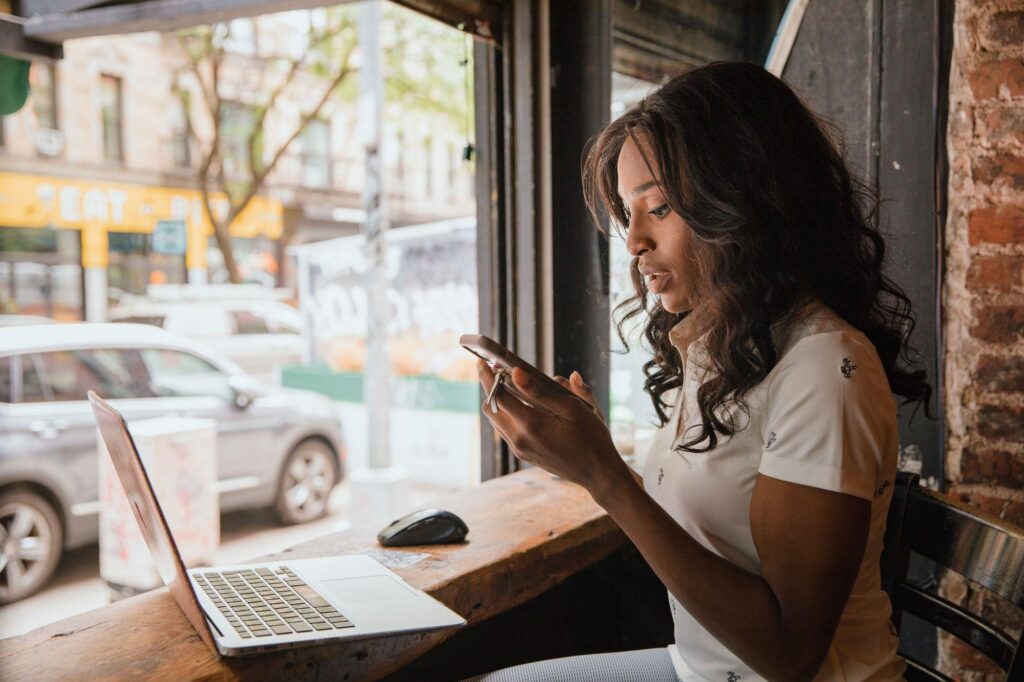 Employee using a personal phone and laptop for work under a BYOD policy