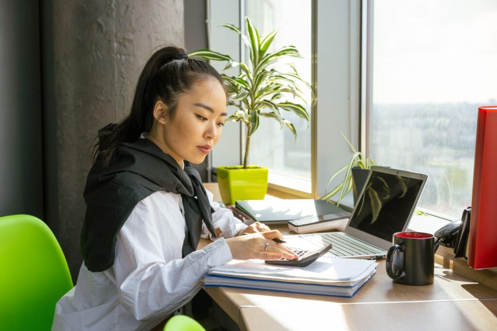 Business owner reviewing computer and equipment costs for a small business IT budget